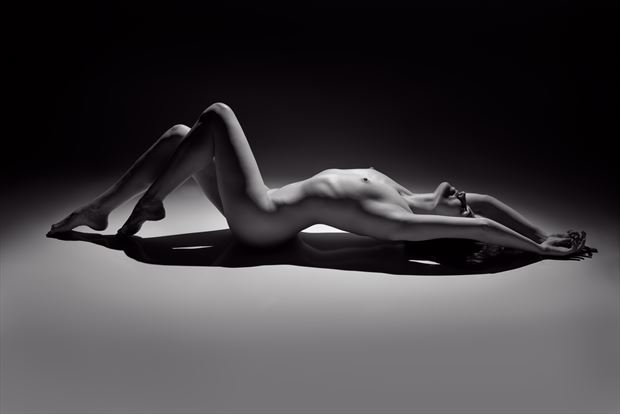 artistic nude studio lighting photo by photographer under black light