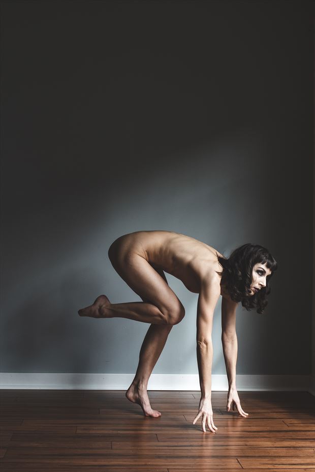 crouched in light artistic nude photo by photographer eldritch allure