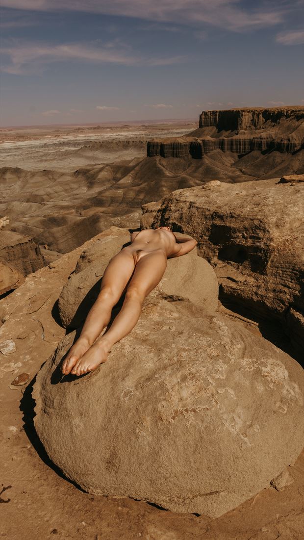 lying on a rock self portrait artistic nude photo by model pure rebel