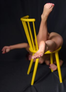 one yellow chair artistic nude artwork by photographer photo kubitza