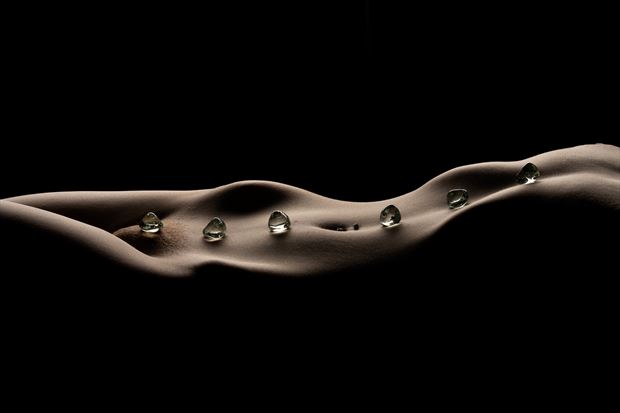 long waves with stones artistic nude photo print by photographer musingeye